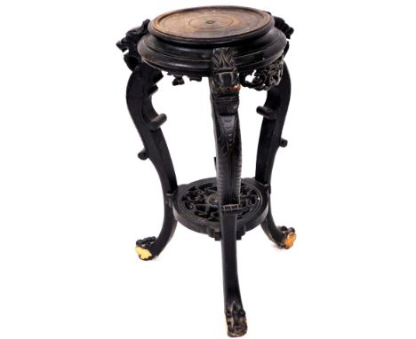 A 19thC Chinese ebonised plant stand, of circular form with S scroll dragon stiles, joined by a carved under tier, set with f