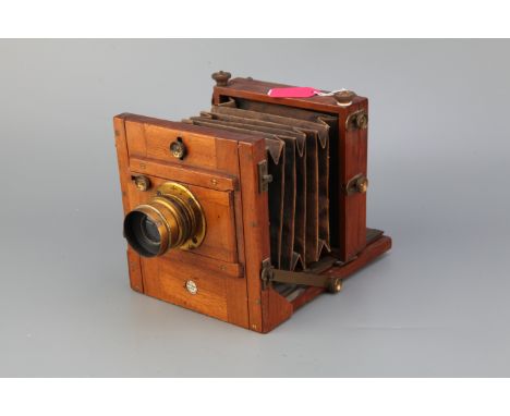 An E & T Underwood Quarter Plate Mahogany Tailboard Camera, with unmarked brass lens Import Duty These items have been brough