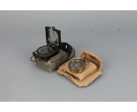 Two Military Compasses,&nbsp; a Verners pattern WWI prismatic compass in a WWII webbing case, glass cracked; alater Mk1 march