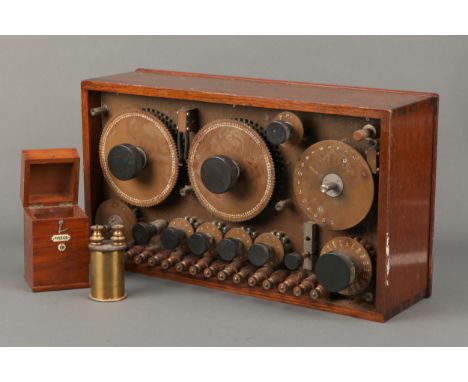 A Large Adjustable Electric Bridge, unsigned, with large rotating dials in polished teak cabinet, with another brass electric