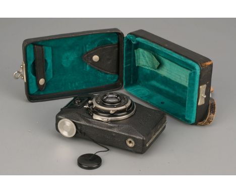 A Zeiss Ikon Kolibri Camera, with Carl Zeiss Jena Tessar f/3.5 50mm lens, lacking support leg, in maker's caseImport Duty The