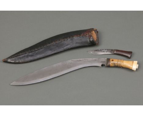 A Kukri, Gurkha Knife, with an ivory &amp; horn handle, leather scabbard and sharpening knife.