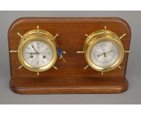 A 8-day Ship's Bell Clock and Barometer,&nbsp; by Shatz, clock with matching aneroid barometer mounted on mahogany stand, com