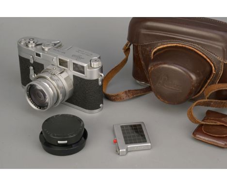 A Leica M3 Rangefinder Camera, chrome, serial no. 742304, with Leitz Summicron Dual-Range f/2 50mm lens, lacking ocular attac