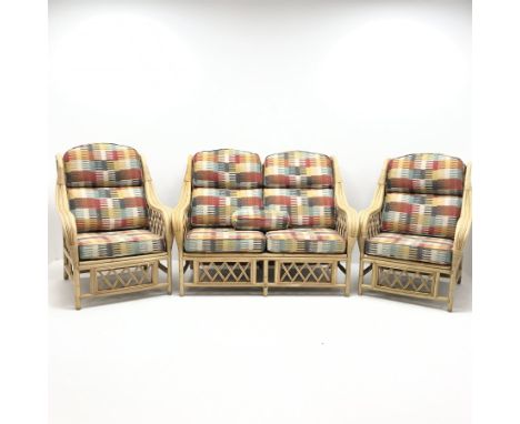 Two seat bamboo framed conservatory sofa, upholstered in a multicoloured patterned fabric (W132cm) and two matching armchairs