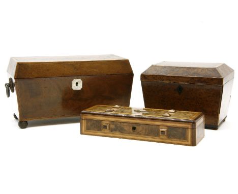 A George III mahogany and boxwood inlaid tea caddy of sarcophagus form, fluted with two divisions, 30cm wide, 16cm deep, 17cm