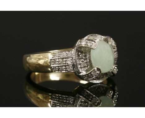 A 9ct gold jade cabochon and diamond cluster ring,with three-row diamond set shoulders.  4.75g.Finger size N