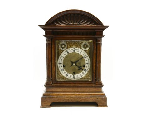 A 19th century oak eight day bracket clock, with silvered chapter ring and brass dial, with cast spandrels, 43 cm high