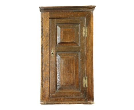 A early 18th century oak corner cupboard, single fielded panel door enclosing shelf, 55 x 32 x 95 cm