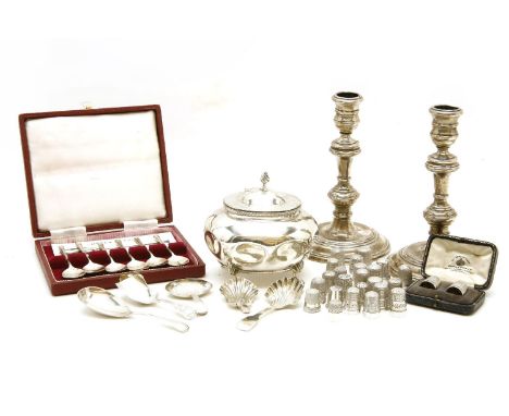 A collection of silver items, to include a tea caddy, a cased set of six teaspoons, caddy spoons, candlesticks and a quantity