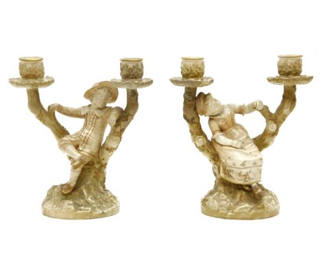 A pair of Royal Worcester twin branch candelabra, the central figural decorated branch flanked to either side with outswept t