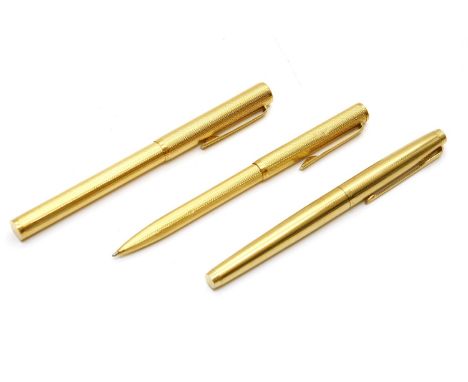 A yellow metal Dunhill fountain pen and ball point set, each with engine turned decoration, together with a rolled gold parke