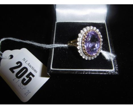 AN AMETHYST AND DIAMOND CLUSTER RING