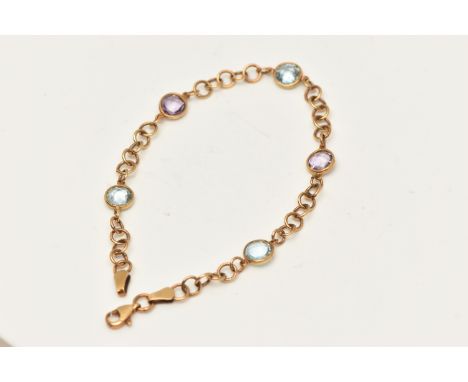 A 9CT GOLD BRACELET, set with three faceted blue paste and two light purple paste, interspaced with Rolo links fitted with a 