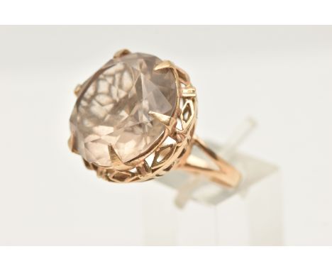 A 9CT GOLD LARGE SMOKY QUARTZ DRESS RING, set with a circular cut smoky quartz, approximate diameter 20.3mm, in a six claw se
