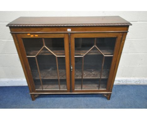 A 20TH CENTURY MAHOGANY BOOKCASE, with double glazed doors, enclosing three shelves, width 121cm x depth 35cm x height 116cm,