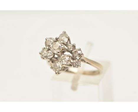 AN 18CT WHITE GOLD DIAMOND CLUSTER RING, asymmetrical cluster of various sized old cut diamonds, in raised claw settings, ten