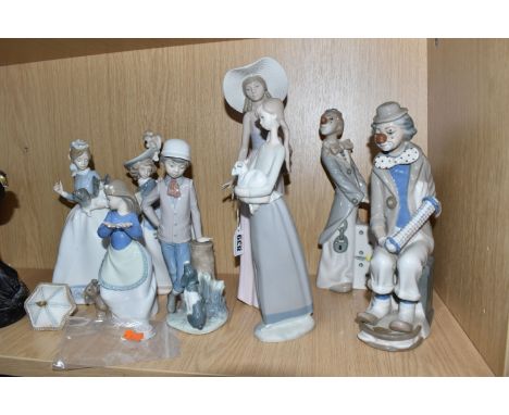 EIGHT SPANISH CERAMIC FIGURINES to include a group of Nao figurines comprising a figure carrying a parasol and small dog (par