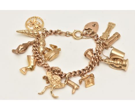 A YELLOW METAL CHARM BRACELET, curb link bracelet with links stamped 9ct, fitted with a heart padlock clasp stamped 9ct and b