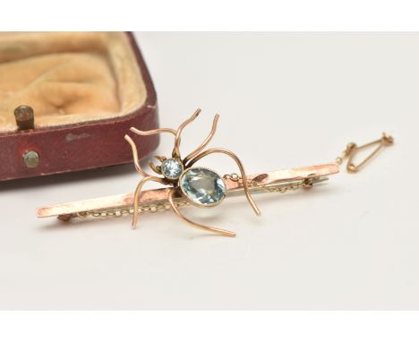 A ROSE METAL SPIDER BAR BROOCH, the body of the spider set with an oval cut and circular cut blue paste each in a milgrain co
