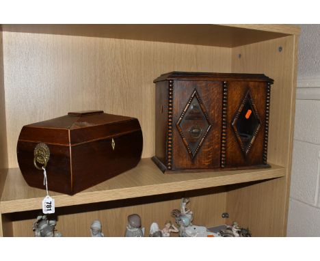 AN OAK SMOKERS CABINET AND A SARCOPHAGUS SHAPED TEA CADDY, the oak tea caddy has diamond shaped glass panels and beaded desig