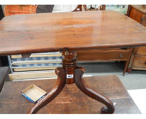 A mahogany tripod table