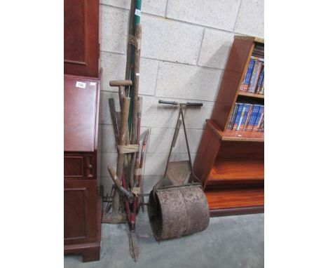 A quantity of garden tools including roller
