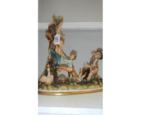 A Capo di monte figure group of children playing