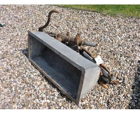 A galvanised half round trough, a pump, and a mangle