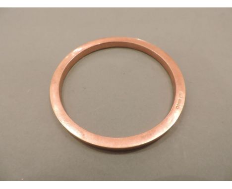 A 9ct rose gold hollow flat section slave bangle