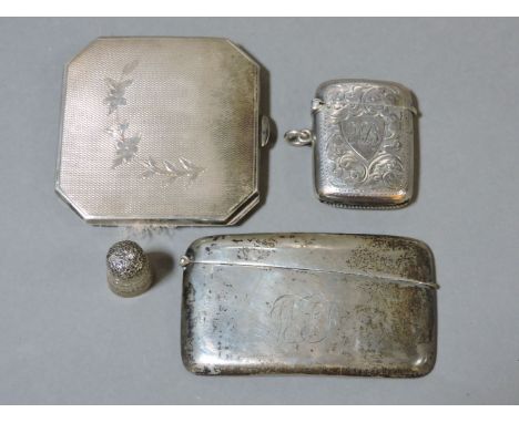 A ladies silver compact, a silver card case, a vesta, and a silver thimble