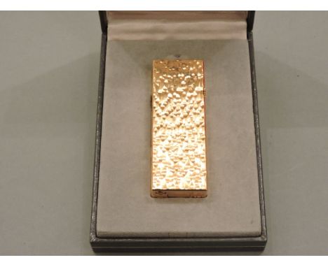 A Dunhill gold plated bark textured lighter, in original box