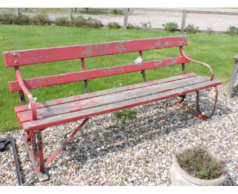 A wrought iron garden bench, painted red, 197cm
