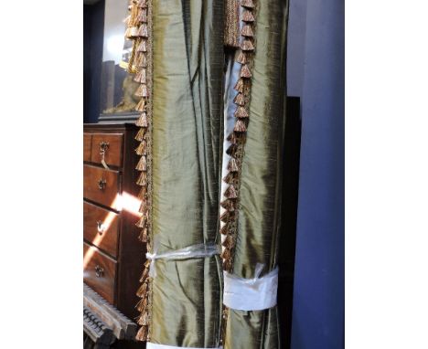 A pair of green silk dupion curtains, lined, interlined and weighted with red, green and cream tassel trim, together with ano