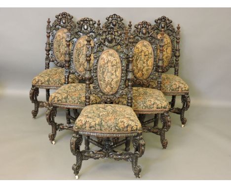 A set of six Victorian carved oak dining chairs, with 'Hunting Boy' tapestry upholstery