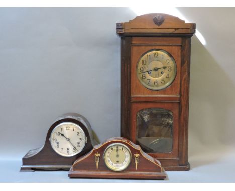 An Art Nouveau inlaid mantel clock, a wall clock, and another mantel clock