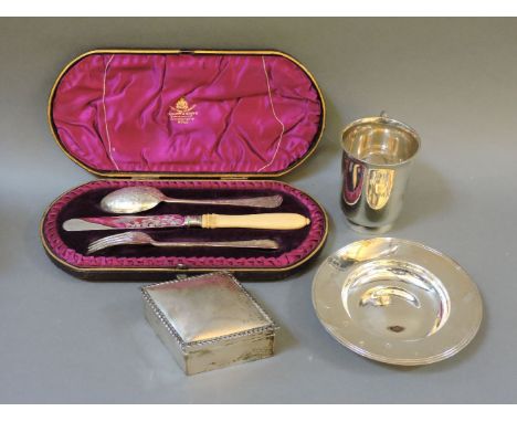 A silver Armada dish, a silver christening mug engraved 'J le MC', a boxed christening cutlery set with engraved fern pattern