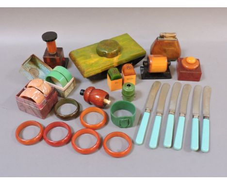 Bakelite and plastic items, including a rare Colibri lighter, blotter, napkin rings, calendar, inkwell, twig coral necklaces,
