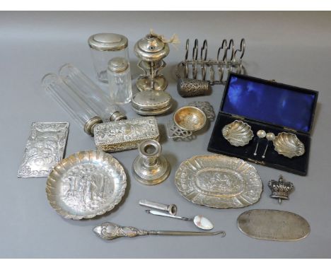 A silver six division toast rack, a pair of cased silver salts, a silver table lighter, silver topped pot/bottles, etc