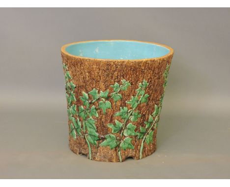 A Minton majolica pottery planter, dated 1870, modelled as a tree stump with ivy, impressed marks and date code, restored, 45