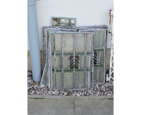 A collection of leaded windows, most centred with a rectangular arrow motif, largest 40 x 158cm