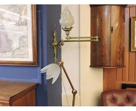 A Victorian brass extending wall light, and a copper angle poise light