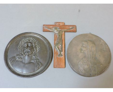 A 19th century bronze roundel, of a lady in a headdress, a small crucifix, and a late 19th century bronze roundel bust of Chr