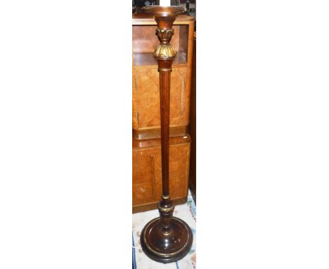 A CARVED WALNUT AND GILT STANDARD LAMP