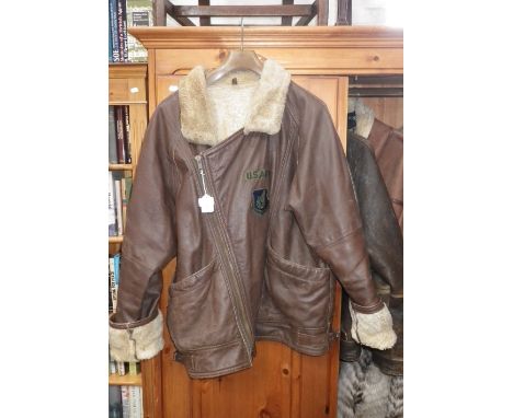 A GENTLEMAN'S BROWN LEATHER FLYING JACKET with a sheepskin lining with a "U.S. Army" badge and a "Pacific Air forces" badge t