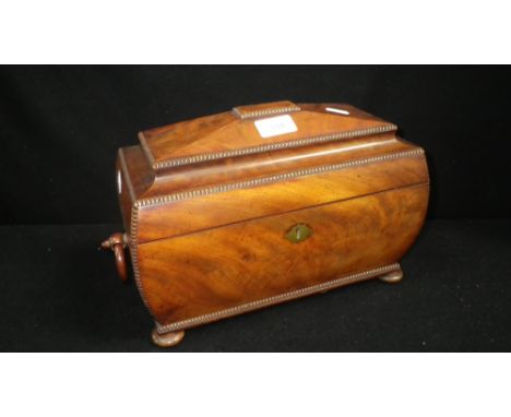 A REGENCY MAHOGANY TEA CADDY of sarcophagus form, fitted two lidded compartments