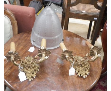 A PAIR OF GILT METAL LOUIS XV STYLE WALL SCONCES, together with a 1920's frosted glass light shade