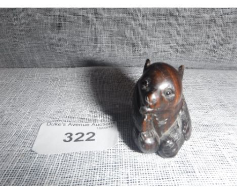 A SMALL JAPANESE HARDWOOD NETSUKE in the form of a small bear