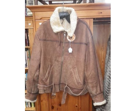 A GENTLEMAN'S BROWN SUEDE FLYING JACKET with a sheepskin lining and a "United States Army" badge to the front