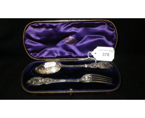 GOLDSMITH & SILVERSMITH CO, LONDON: A CASED SILVER SPOON AND FORK with engraved foliate decoration